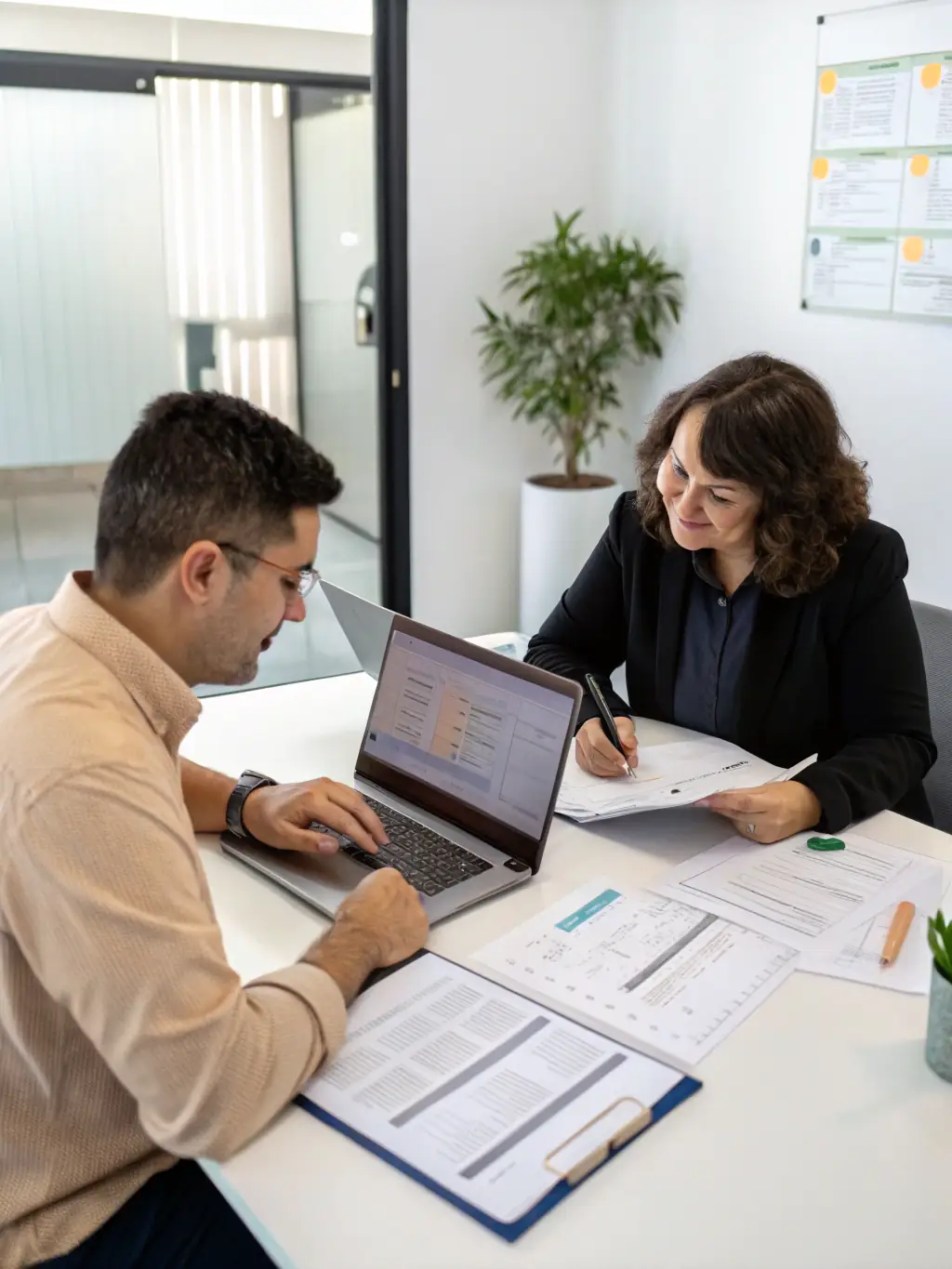 A small business owner reviewing financial statements with an accountant in a modern office, emphasizing collaboration and financial expertise.